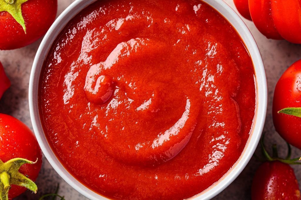 Homemade tomato sauce in gray bowl. Cooking from summer vegetabl